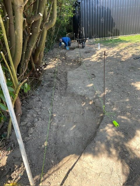 Marking out a new border edge along a fence line