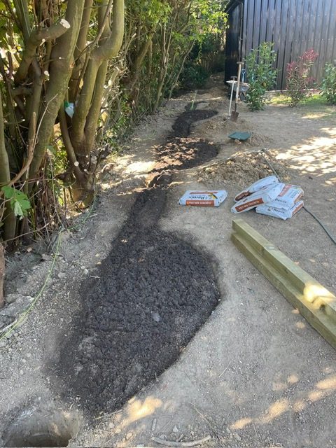 Digging a new border edge along a fence line