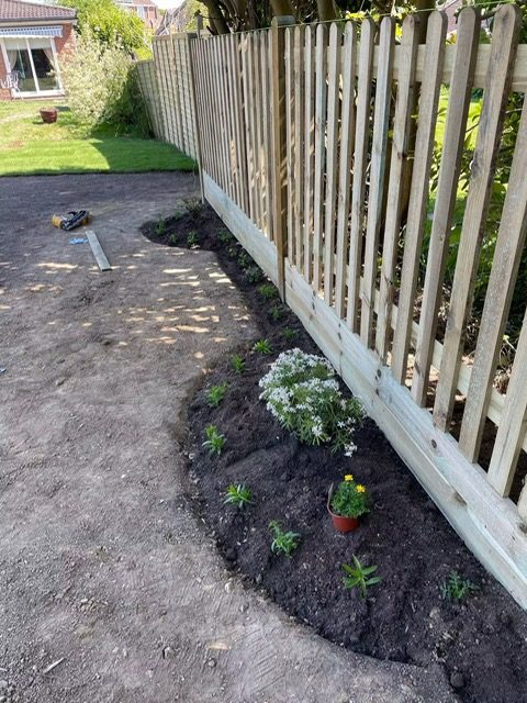 New fence with freshly planted bed