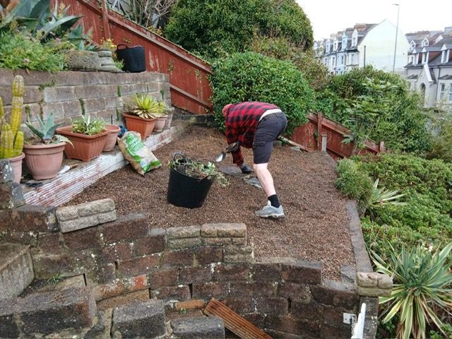 SJR team member working on a tiered garden border